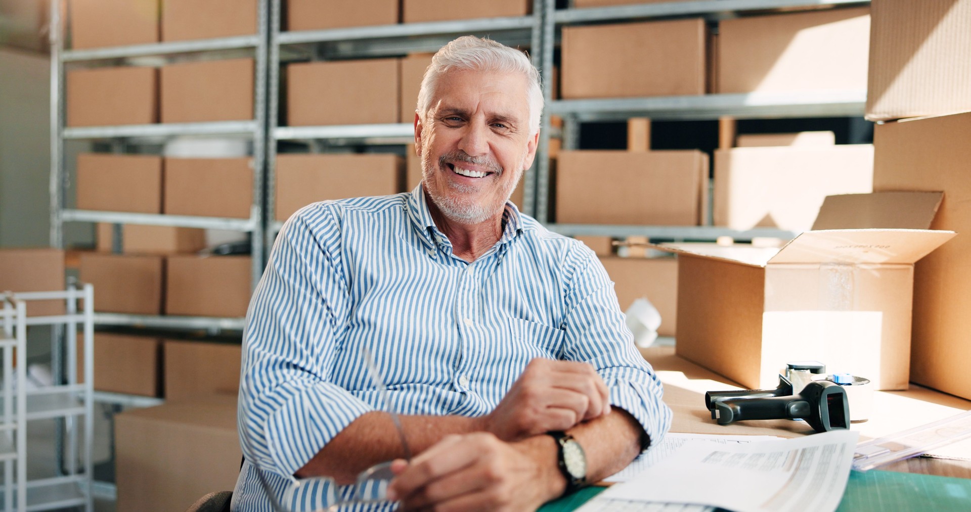 Business, logistics and portrait with mature man in office for delivery, distribution or planning. Ecommerce, shipping and smile of happy employee in workplace for export or supply chain management